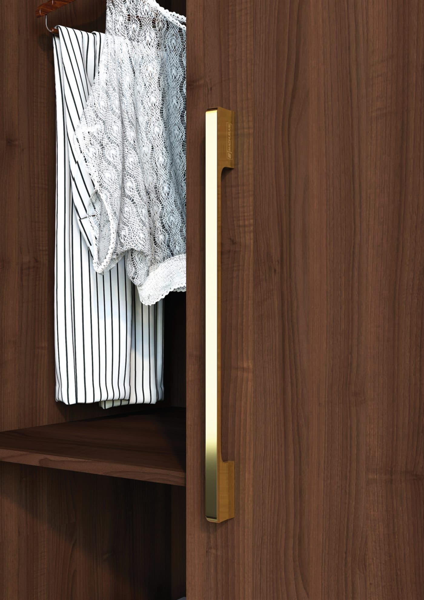 Brushed-gold wardrobe pull on walnut