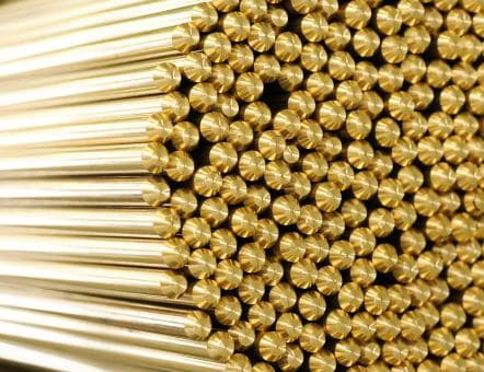 Madhuram brass round rods — close-up of pure-metal extrusion stock